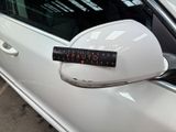 a sticker on the side mirror of a white car