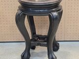 a small black table with a marble top on it
