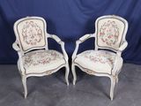 pair of antique french style chairs with floral upholstered cushions