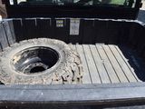a truck bed with a tire in the back of it