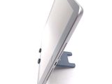 a tablet computer sitting on a stand on a table