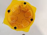 un objet jaune posé sur une surface blanche
