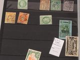 many different stamps on display in a black case