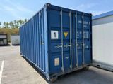 a blue shipping container sitting in a parking lot