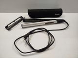 a hair dryer and a hair brush on a table