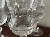 several empty wine glasses sitting on top of a table next to a candle