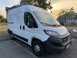 the white van is parked in the parking lot with the sun setting