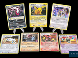 several pokemon cards are lined up in a row on a black background