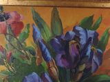 painting of flowers in a gold frame on a yellow background