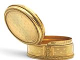 an image of a gold box with a lid on a white surface