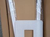a toilet in a box with a toilet paper roll sticking out of it