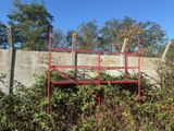 a red scaffolding on the side of a concrete wall