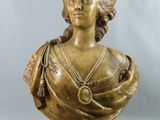 un buste antique en bronze représentant une femme portant un collier autour du cou