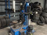 a machine that is sitting in front of a pile of tires