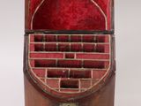 a small wooden box with a red lining on it