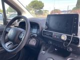 a car dashboard with a monitor and a steering wheel