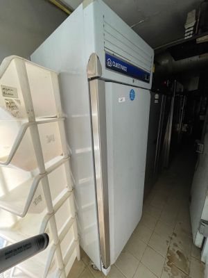 a refrigerator that is sitting in the middle of a room
