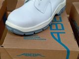 a pair of white shoes sitting on top of a box