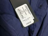 a close up of a blue jacket with a tag on it