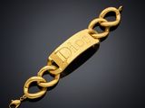 a gold bracelet with the word ' person ' engraved on it