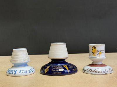 three small vases sitting on top of a table next to each other
