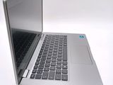 a silver laptop computer sitting on a white surface