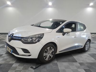 the white car is parked in the garage on a checkered floor
