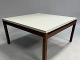 the table is made of wood and has a white top