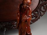 an image of a wooden statue of a woman holding a baby