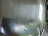 a silver vase sitting on top of a table