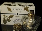 an image of a bottle of perfume next to a box on a table