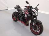 a black and red motorcycle parked in a white room
