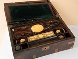 a wooden box with a writing set inside of it