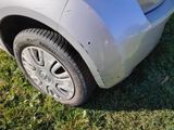 a close up of a car ' s front bumper and tire