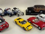 several toy cars are lined up in a row on a white surface