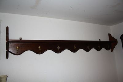 a picture of a coat rack in the corner of a room