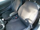 two seats in the back of a car with a steering wheel
