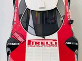 a model of a race car on display on a white surface