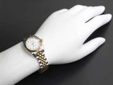 an image of a woman ' s wrist with a watch on it