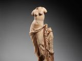 a carved ivory figure of a woman with a bird on her shoulder