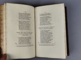 someone is holding a book open on a gray surface