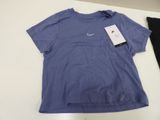 blue nike t - shirt and black leggings on a white table