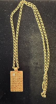 a gold plated necklace with a square pendant on a chain