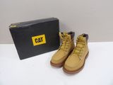 yellow boots with yellow laces and a black box on a white surface