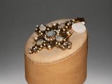 an image of a wooden box with a ring on top of it