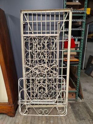 an old white iron screen with a decorative design on it