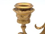 a gold candle holder on a white background