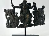 bronze statue of a man on a horse with a group of people around him