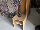 a statue of a man standing on a stool next to a chair