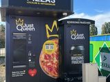 a vending machine that has a pizza on the front of it